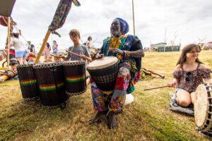 Man and children African drumming