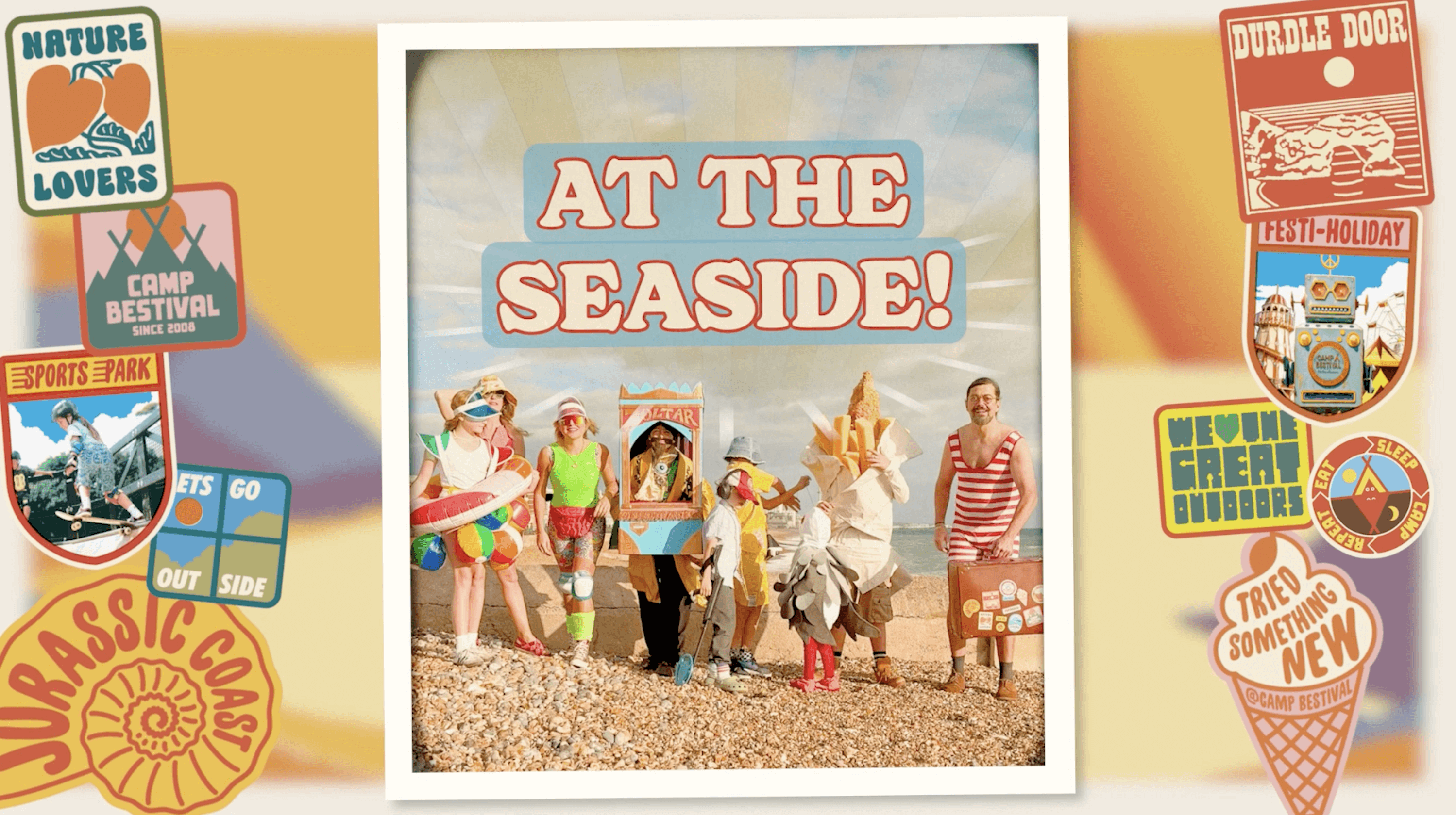 People in seaside themed fancy dress on a beach with At The Seaside! wording above them
